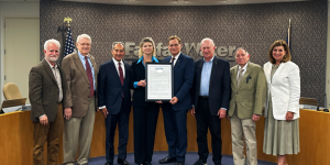 A photo of the Fairfax Water Board members presenting a framed proclamation to retiring Fairfax Water General Manager Jamie Hedges