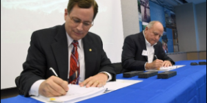 Philip W. Allin, Fairfax Water’s Chairman, and William “Kim” Duke, Vulcan’s Mideast Division President, sign the final documents for the official sale and purchase of a portion of Vulcan Materials land for the creation of a new reservoir in Lorton, Virginia, Oct. 25. (Photo courtesy of Fairfax Water)